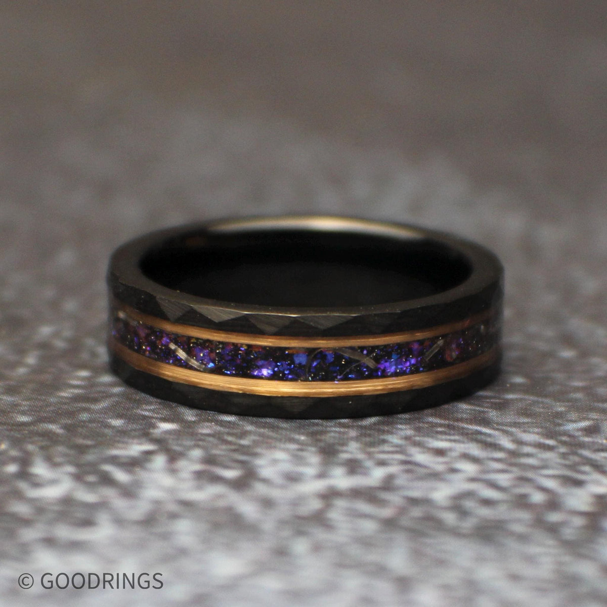 Straight front view of the galaxy-inspired tungsten wedding band, showing its shimmering purple center, silver meteorite shavings, and warm accent lines.