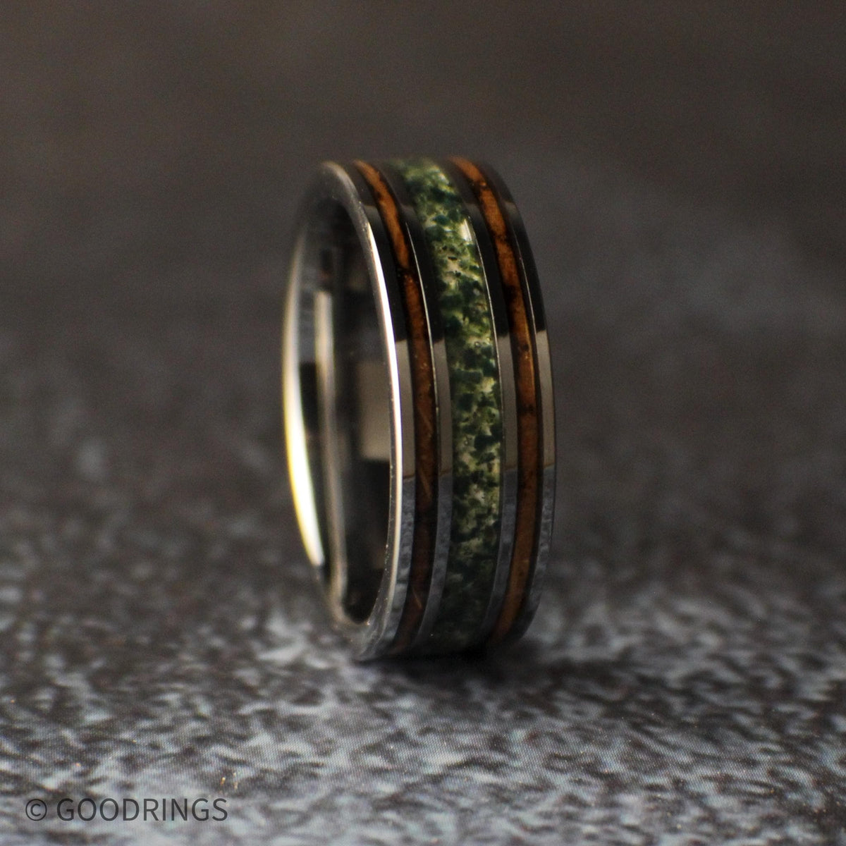 Slightly angled view of a burnt whiskey barrel and moss agate ring