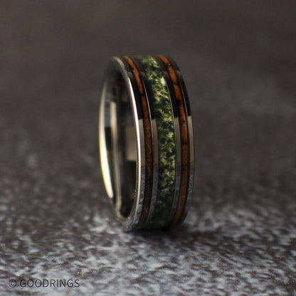 Slightly angled view of a burnt whiskey barrel and moss agate ring