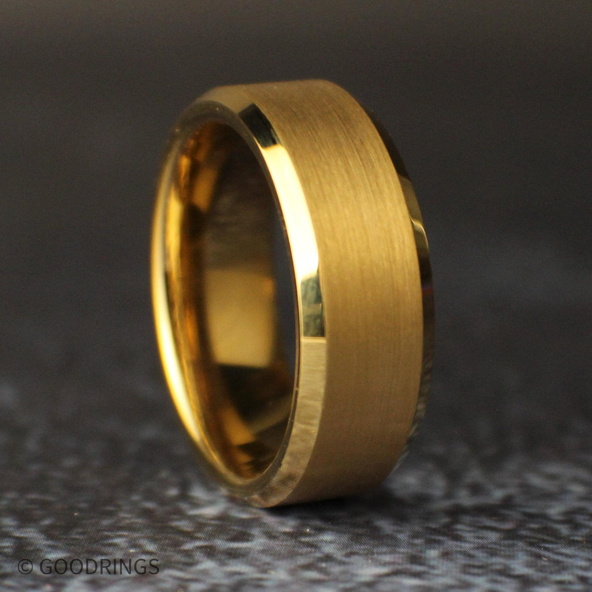 Straight front view of an 8mm brushed gold wedding band lying horizontally, with a satin-finished center and polished beveled edges.