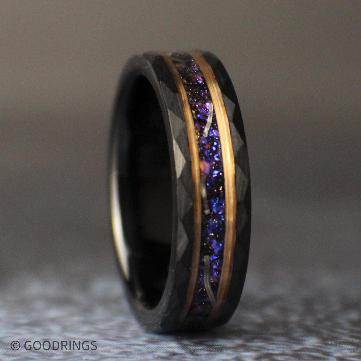 Straight front view of the 6mm galaxy tungsten band lying horizontally, with a sparkling purple-blue center, meteorite shavings, and warm accent lines.