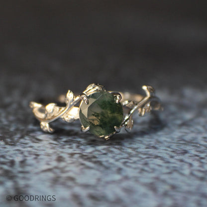 Darker moss agate stone on a sterling silver band with leaf design