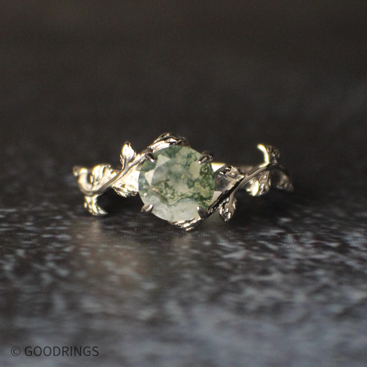 Moss Agate ring with white gemstone and green moss agate lines.