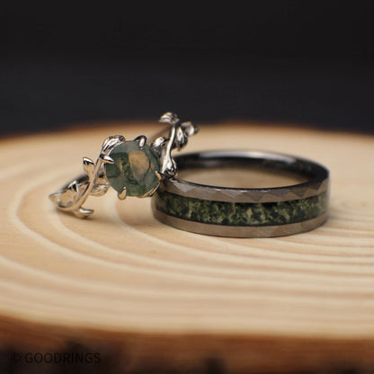 Picture of a women's moss agate wedding ring leaning on a mens moss agate wedding band.