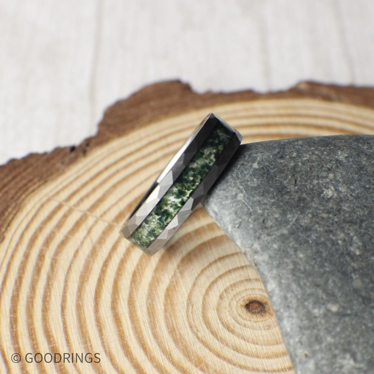 Top view of mens moss agate ring in a silver hammered core.