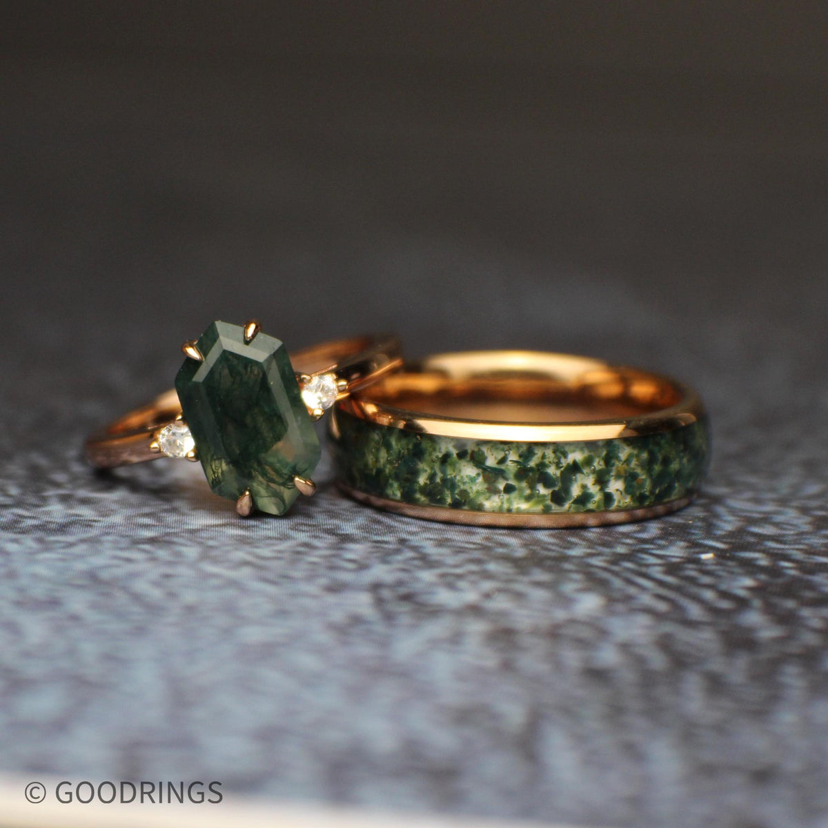 Picture of a female moss agate ring laying on a males 6mm wide moss agate ring.