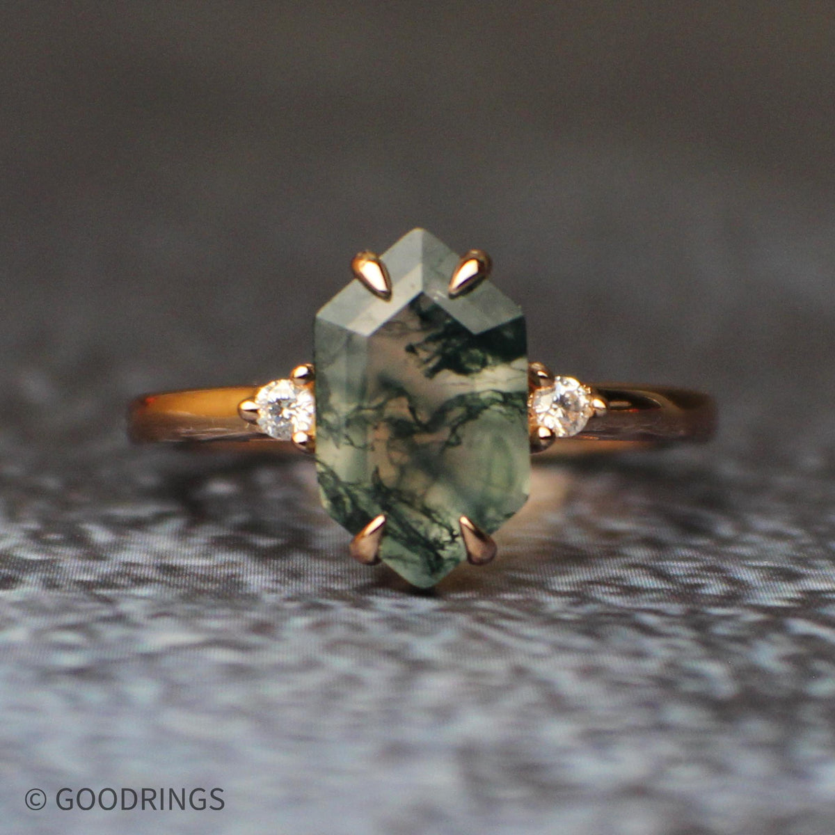 Close up image of a female moss agate wedding ring