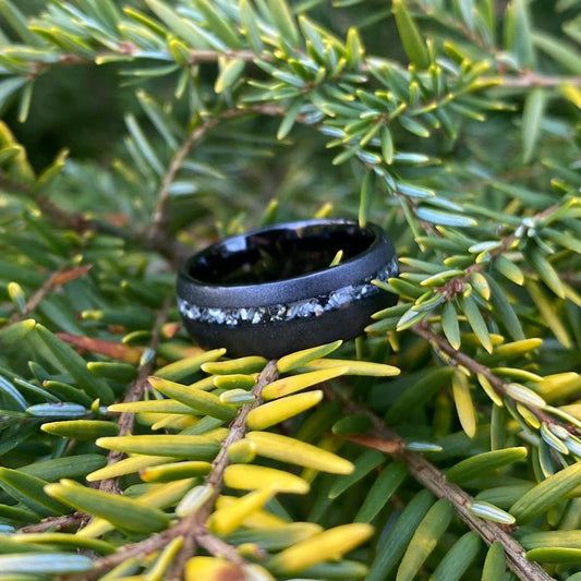 Men's wedding ring made out of sand blasted tungsten with an offset of meteorite
